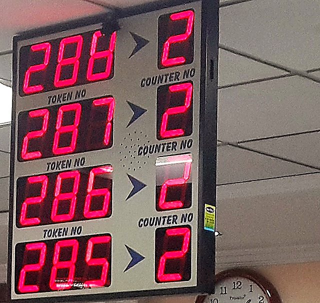 LED wireless queue display at a Canara Bank branch showing four token and counter pairs