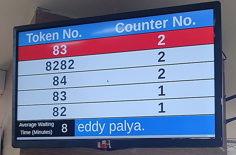 Bank queue display at a State Bank of India branch showing tokens, counters and an eight minute average waiting time